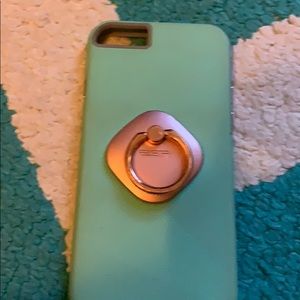 A blue phone case with a gold ring with diamonds
